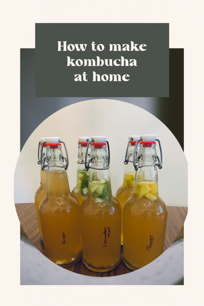 how to make kombucha at home. six glass bottles of flavored kombucha.