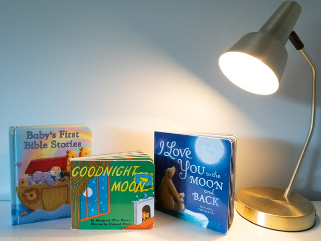 three best baby books on a shelf with a lamp on