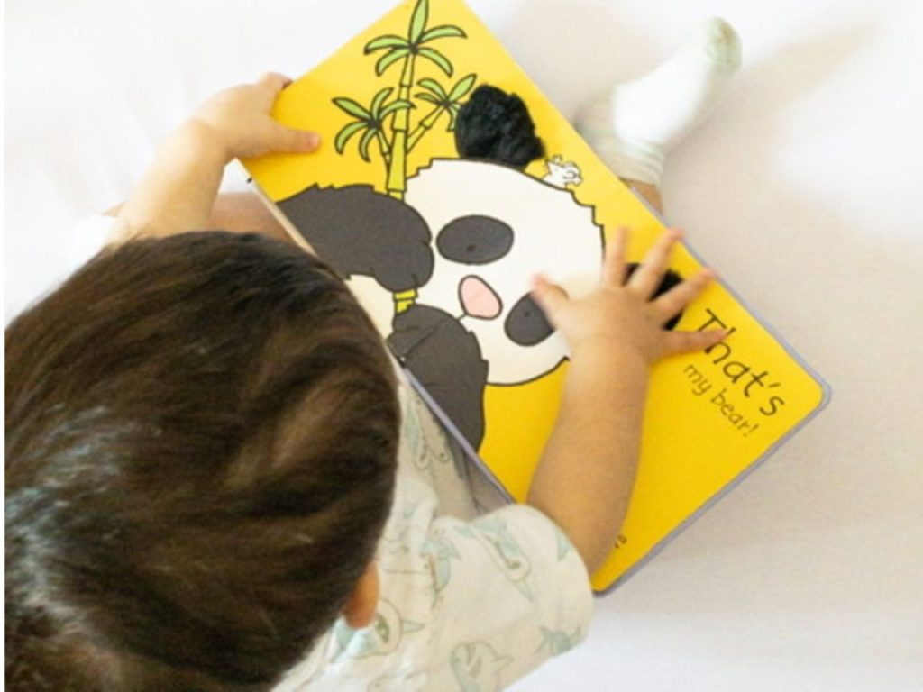 baby reading that's Not My Bear
