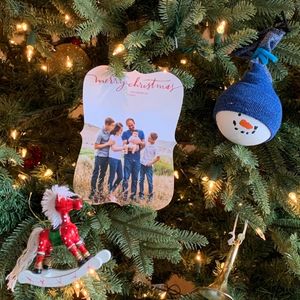 Christmas cards, heirloom, and handmade ornaments on a Christmas tree
