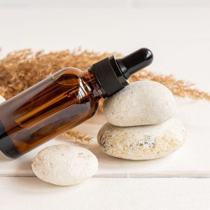 amber glass bottle filled with copaiba essential oil beauty blend