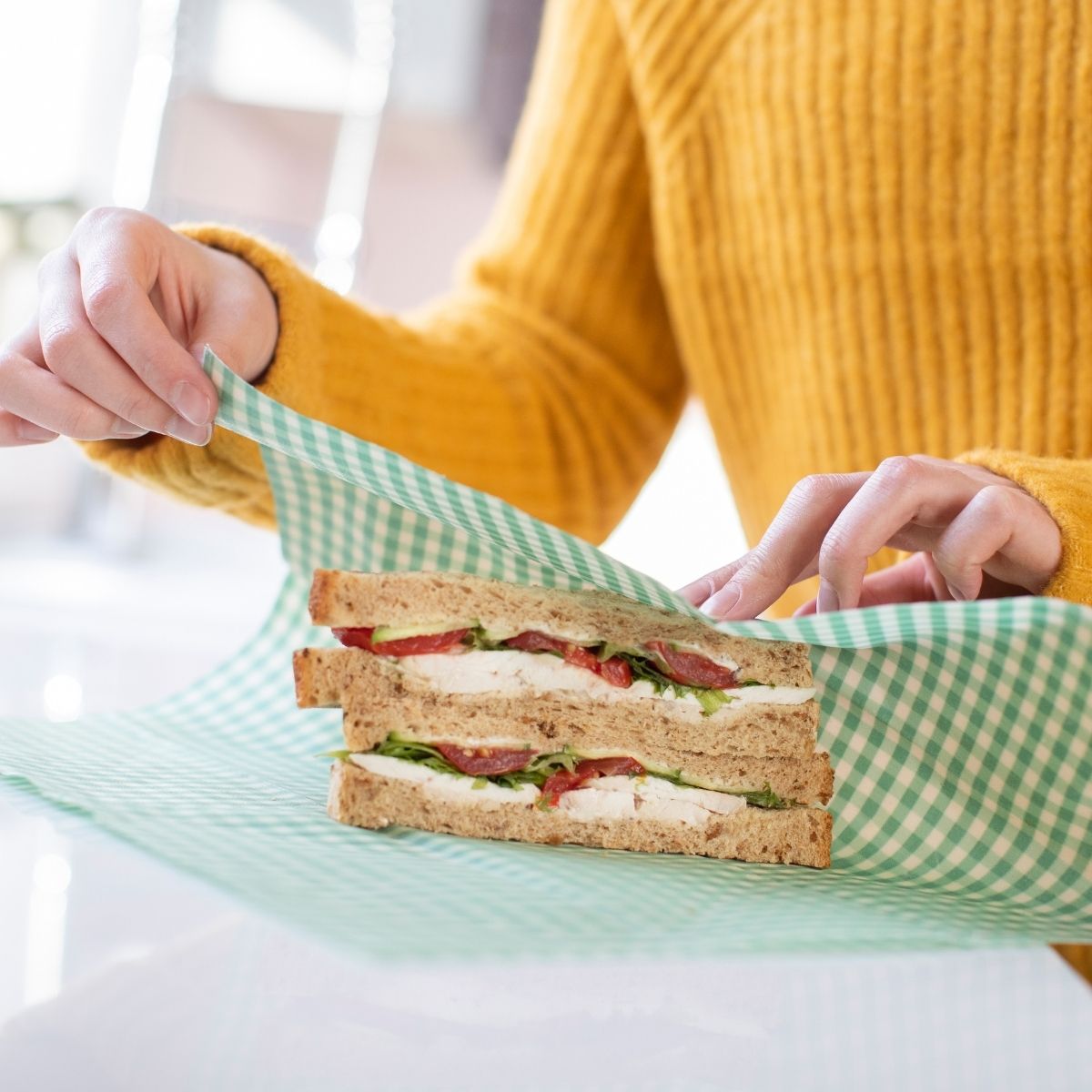 sandwich being wrapped in beeswax wrap