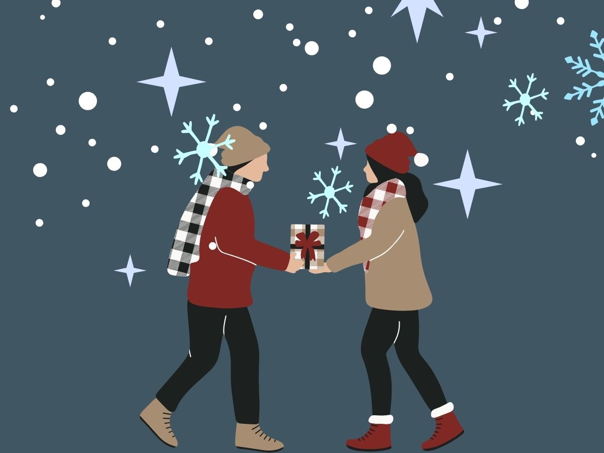Two teenagers exchanging a Christmas gift in a snowy winter scene