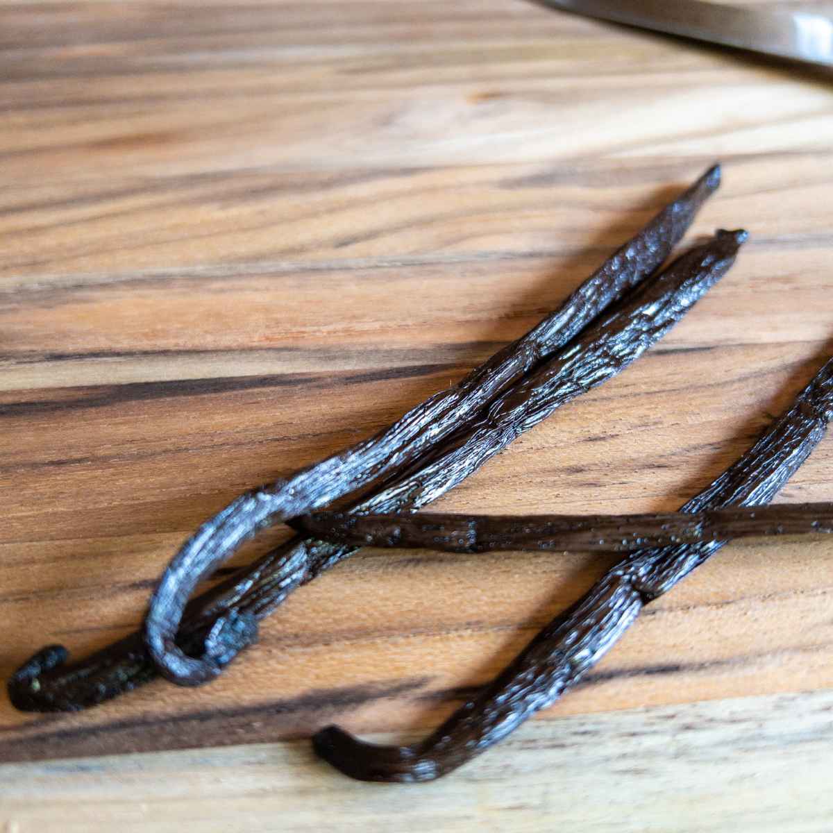 whole vanilla beans on a cutting board