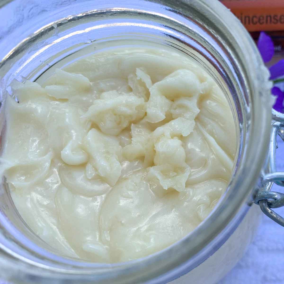 homemade breast milk lotion in a glass jar