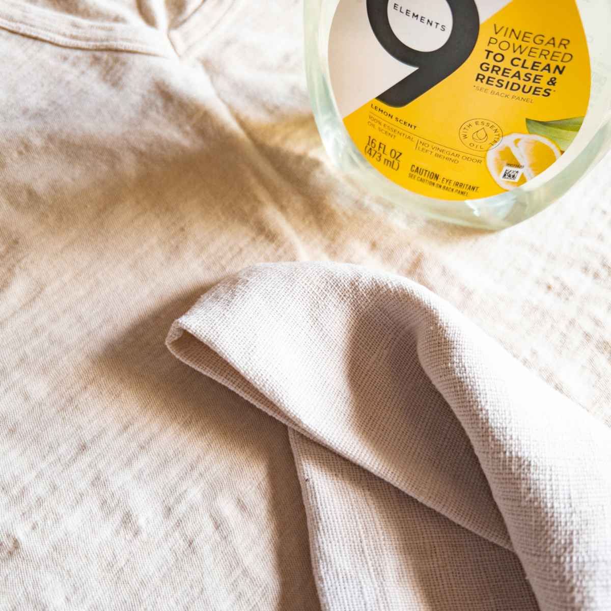 white cleaning rag and dish soap on a shirt