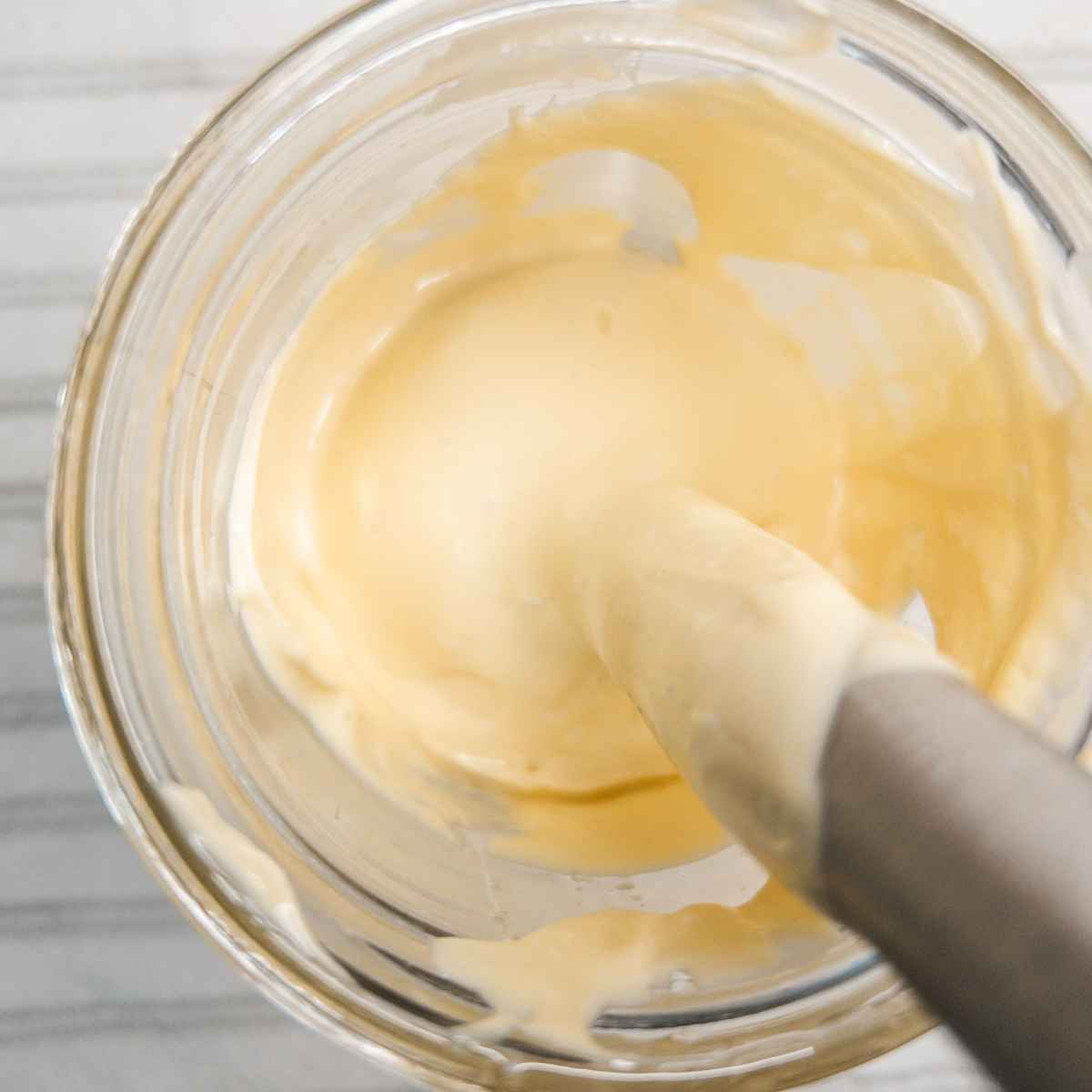 using an immersion blender to blend all kombucha mayo recipe ingredients