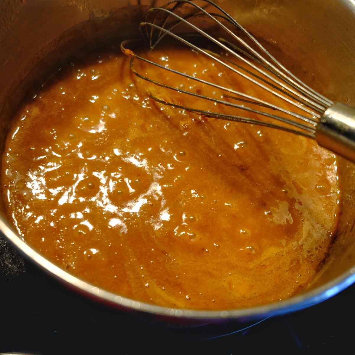 reheating gravy on the stovetop and using a whisk to mix