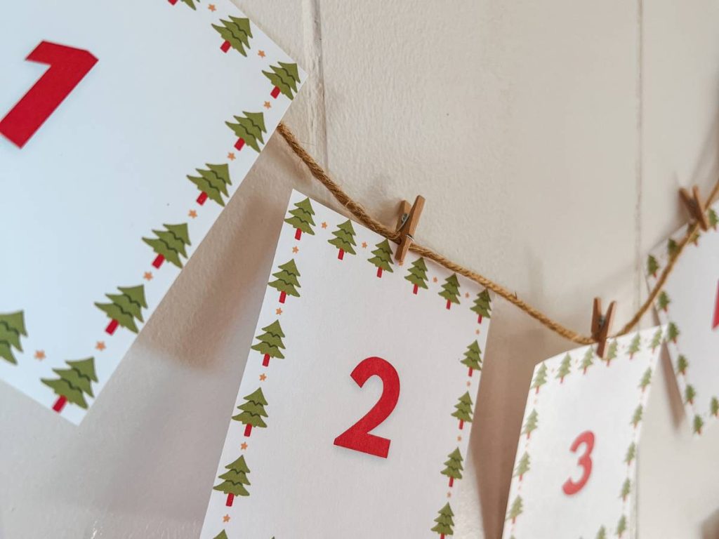 Christmas countdown banner hung on a wall with twine and mini clothespins