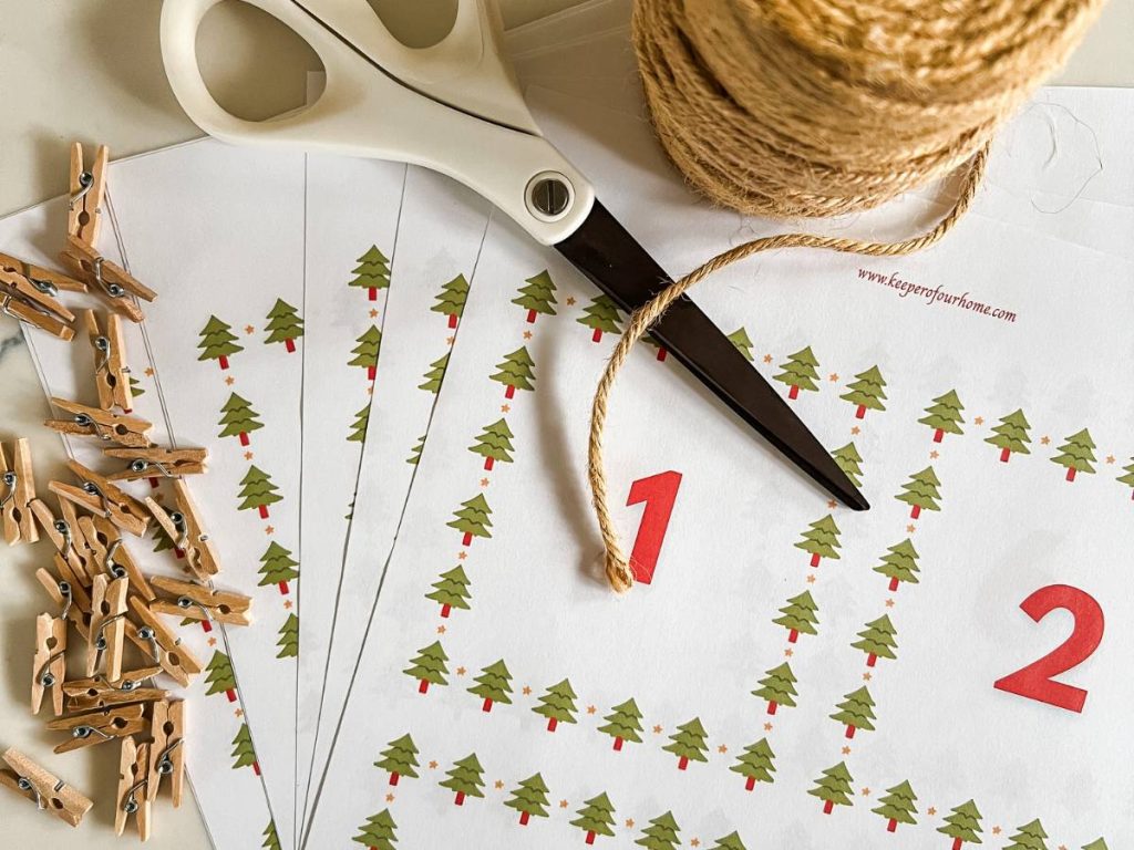 printable christmas countdown number sheets, scissors, twine, and mini clothespins.