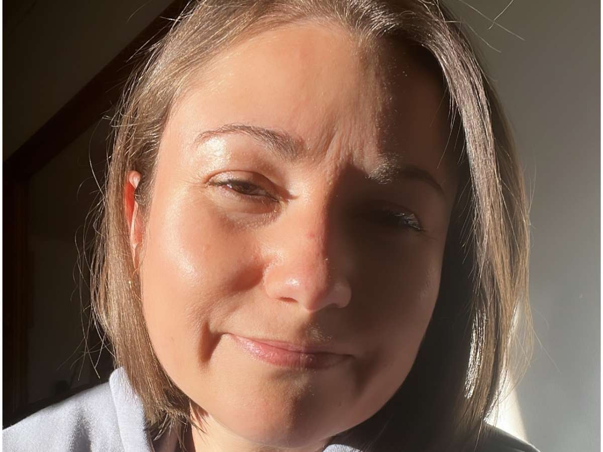 a mom sitting by a sunny window